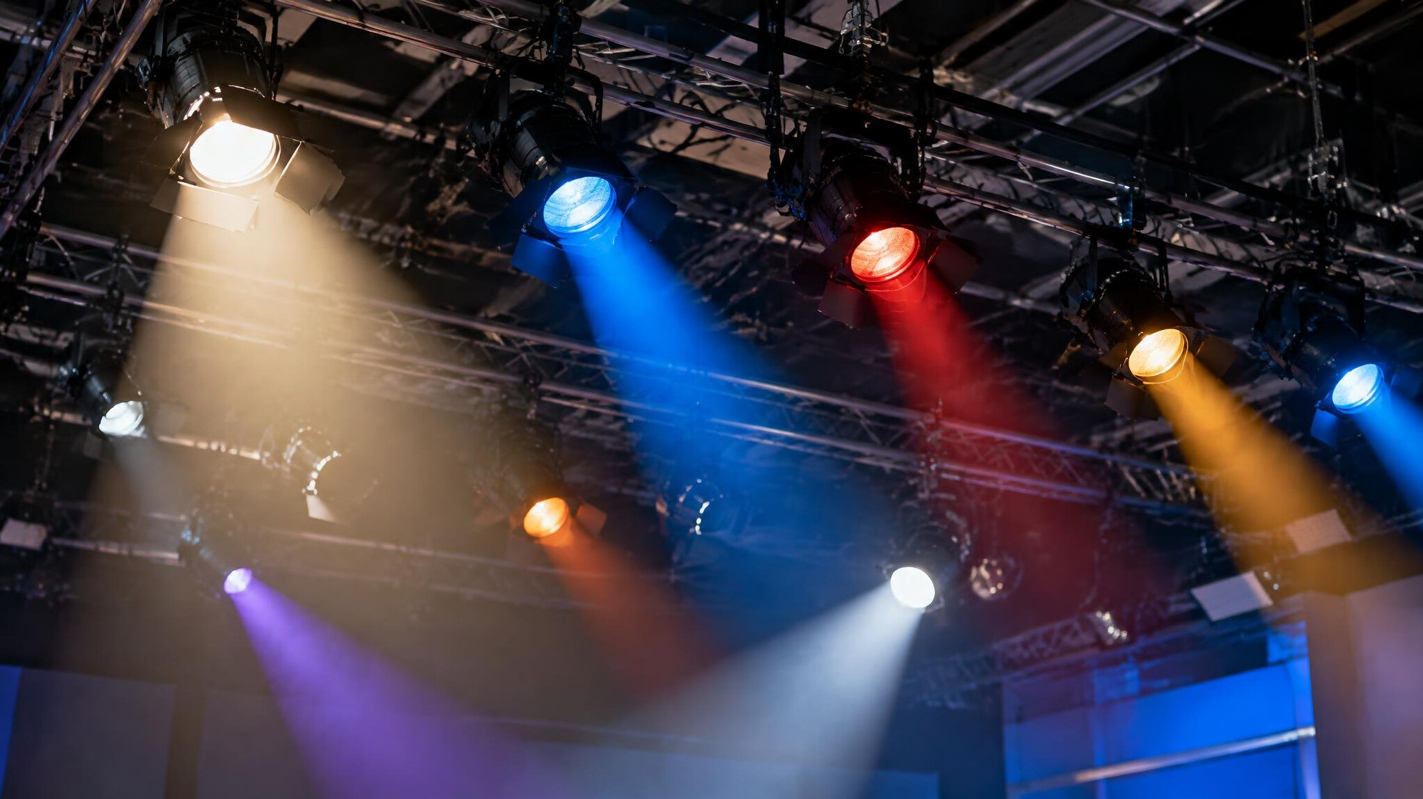 Stage lighting rig with colored gels in a television studio