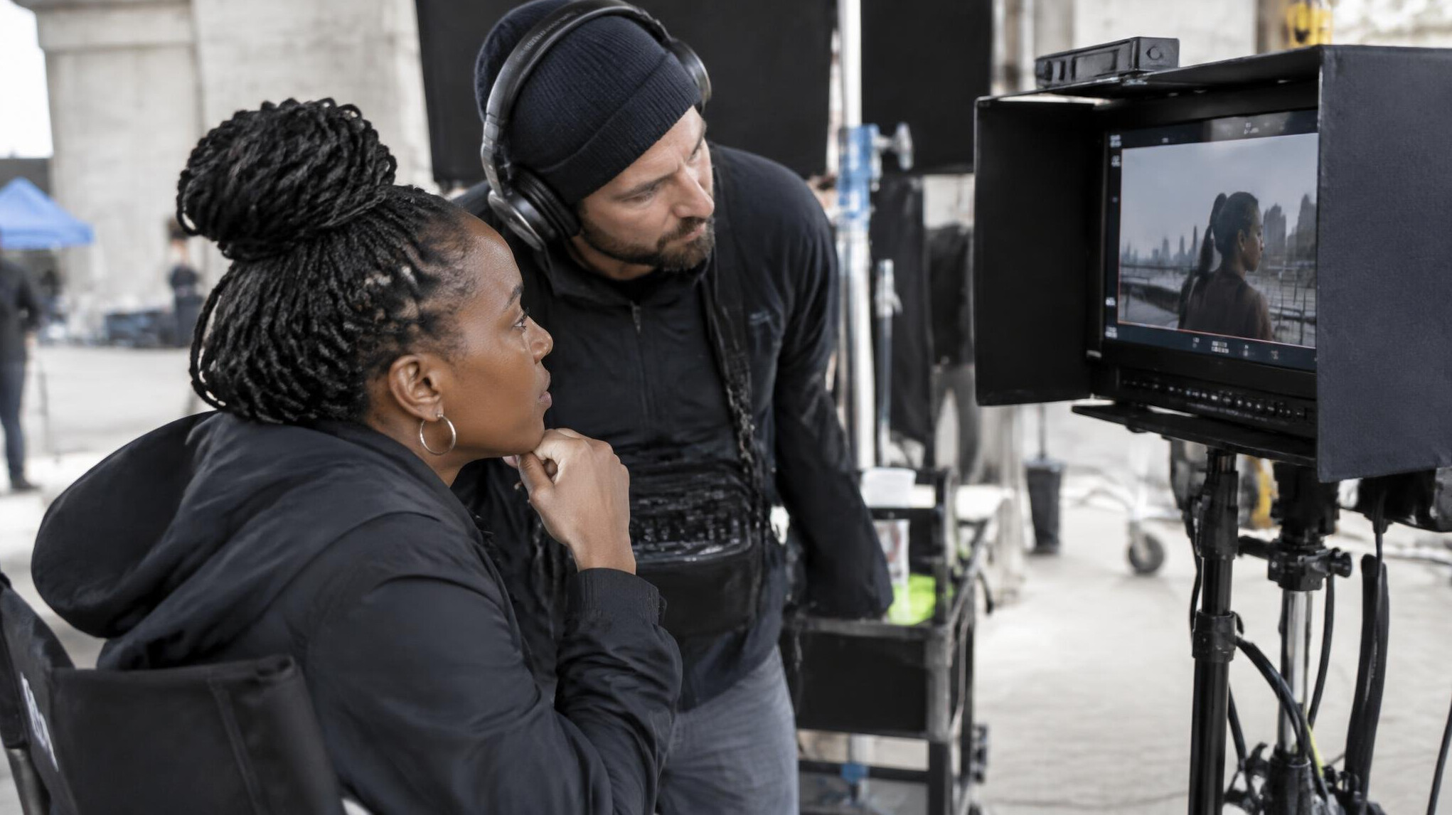 Production team reviewing footage on a monitor behind the camera